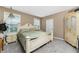 Bright bedroom with a large bed and neutral decor at 12753 Sagewood Dr, Venice, FL 34293