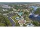Aerial view of community amenities, including a lake, playground and pool at 12753 Sagewood Dr, Venice, FL 34293