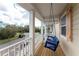 Relaxing front porch with a blue swing overlooking the neighborhood at 12753 Sagewood Dr, Venice, FL 34293