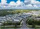 Aerial view of a residential community with houses, roads, and lush green landscaping at 12753 Sagewood Dr, Venice, FL 34293
