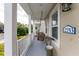 Charming front porch with a swing and a view of the street at 12753 Sagewood Dr, Venice, FL 34293