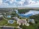 Aerial view of community features including pools, playground, and lake at 12753 Sagewood Dr, Venice, FL 34293