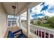 Spacious front porch with a blue swing and a neighborhood view at 12753 Sagewood Dr, Venice, FL 34293