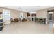 Spacious dining area with tile floors and adjacent kitchen at 12753 Sagewood Dr, Venice, FL 34293
