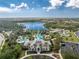 Community pool and clubhouse with a lake view at 12753 Sagewood Dr, Venice, FL 34293