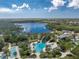 Aerial view of community pool, with a water slide and surrounding landscape at 12753 Sagewood Dr, Venice, FL 34293