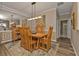 Bright dining room with wood table and chairs, and an area rug at 13215 Amerigo Ln, Venice, FL 34293