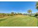 Enjoy the view of the pond from this grassy backyard at 13384 Creekside Ln, Port Charlotte, FL 33953