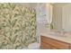 Clean bathroom with updated vanity and a tropical shower curtain at 13384 Creekside Ln, Port Charlotte, FL 33953