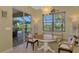 Charming breakfast nook with a round table and access to the backyard at 13384 Creekside Ln, Port Charlotte, FL 33953