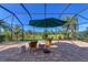 Spacious screened lanai with patio furniture and tranquil view at 13384 Creekside Ln, Port Charlotte, FL 33953