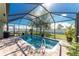 Relaxing screened pool with a flamingo floatie at 13515 Keystone Blvd, Port Charlotte, FL 33981