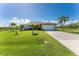 Single-story home with a two-car garage and lush lawn at 13515 Keystone Blvd, Port Charlotte, FL 33981