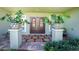 Inviting front entry with double doors and large potted plants at 13515 Keystone Blvd, Port Charlotte, FL 33981