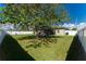 Large backyard with a grassy lawn and mature tree at 13515 Keystone Blvd, Port Charlotte, FL 33981