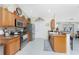 Modern kitchen with stainless steel appliances and wood cabinets at 13515 Keystone Blvd, Port Charlotte, FL 33981