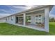 Covered patio with view of backyard and sliding doors at 14304 Amestoy Ave, Port Charlotte, FL 33981