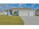 Newly built home with two-car garage and well-manicured lawn at 14304 Amestoy Ave, Port Charlotte, FL 33981
