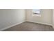 Well-lit bedroom featuring wood-look flooring and a window at 14304 Amestoy Ave, Port Charlotte, FL 33981