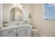 Modern bathroom with white vanity, quartz countertop, and arched mirror at 14304 Amestoy Ave, Port Charlotte, FL 33981