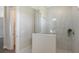 Bathroom with a walk-in shower, marble tile, and a modern glass enclosure at 14304 Amestoy Ave, Port Charlotte, FL 33981