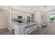 Modern kitchen with white cabinets, quartz countertops, and stainless steel appliances at 14304 Amestoy Ave, Port Charlotte, FL 33981