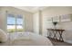 Bedroom with a queen bed, wooden console table, and sliding glass doors to backyard at 14304 Amestoy Ave, Port Charlotte, FL 33981