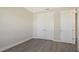Bright bedroom with double doors leading to a closet and gray vinyl plank flooring at 14304 Amestoy Ave, Port Charlotte, FL 33981