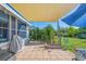 Spacious patio area with shade sail, grill, and bike storage at 14439 Worthwhile Rd, Port Charlotte, FL 33953