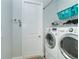 Laundry room with washer, dryer, and overhead storage at 180 Rotonda N Blvd, Rotonda West, FL 33947