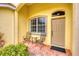 Front porch with two metal chairs and a small table at 1985 Coconut Palm Cir, North Port, FL 34288