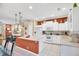 Modern kitchen with white cabinets, a center island, and stainless steel appliances at 1985 Coconut Palm Cir, North Port, FL 34288