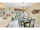 Bright kitchen with breakfast nook, white cabinets, and view of patio at 1985 Coconut Palm Cir, North Port, FL 34288