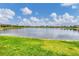 Serene lake view with multiple houses visible in the background at 1985 Coconut Palm Cir, North Port, FL 34288