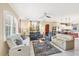 Spacious living room with comfortable seating and large windows at 1985 Coconut Palm Cir, North Port, FL 34288