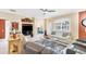 Living room with comfortable seating and view into bedroom at 1985 Coconut Palm Cir, North Port, FL 34288