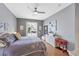 Main bedroom with king bed, wood floors, and sliding doors to the pool at 1985 Coconut Palm Cir, North Port, FL 34288