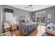 Main bedroom with king bed, wood floors, and sliding doors to the pool at 1985 Coconut Palm Cir, North Port, FL 34288