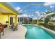 Screened pool area with patio furniture and lake view at 1985 Coconut Palm Cir, North Port, FL 34288