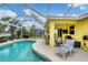 Screened pool and patio area with grill and lounge chairs at 1985 Coconut Palm Cir, North Port, FL 34288