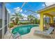 Inviting kidney-shaped pool with screened enclosure and lake view at 1985 Coconut Palm Cir, North Port, FL 34288