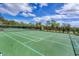 Two tennis courts with surrounding fencing and seating at 1985 Coconut Palm Cir, North Port, FL 34288