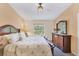 Main bedroom with wood furniture and a large window providing natural light at 268 Rotonda W Blvd # 1B, Rotonda West, FL 33947