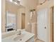 Guest bathroom with single sink and access to the main bedroom at 268 Rotonda W Blvd # 1B, Rotonda West, FL 33947