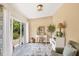 Bright home office features a view of the backyard, built-in shelving, and a cozy sitting area at 268 Rotonda W Blvd # 1B, Rotonda West, FL 33947