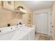 Bright laundry room, featuring washer, dryer, and ample storage at 268 Rotonda W Blvd # 1B, Rotonda West, FL 33947