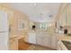 Kitchen features white cabinets and a view of the living room at 268 Rotonda W Blvd # 1B, Rotonda West, FL 33947