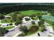 Aerial view of community park with playground, tennis courts, and open green space at 268 Rotonda W Blvd # 1B, Rotonda West, FL 33947