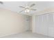 Well-lit bedroom, featuring a ceiling fan and large closet at 289 White Marsh Ln, Rotonda West, FL 33947