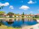 Tranquil pond view of condo community, showcasing building reflections at 309 Pine Hollow Cir # 309, Englewood, FL 34223